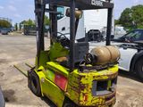 a yellow forklift truck parked in a parking lot