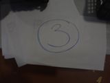 a piece of paper with the number 3 drawn on it
