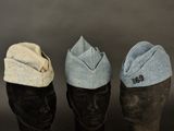 three hats are lined up on a mannequin head