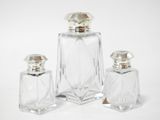 three pieces of glass with a silver top and a silver base