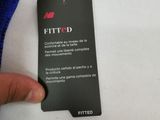 someone is holding a tag that says fitted on a white t - shirt