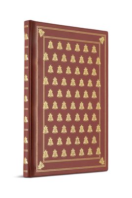 un livre rouge orné de motifs dorés sur fond blanc