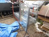 a metal rack with a glass door in the middle of a yard