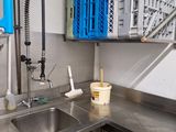 a kitchen with a sink and a bunch of crates