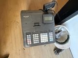 a telephone that is sitting on the floor next to a cup