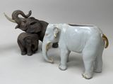 three figurines of elephants standing next to each other