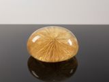 an image of a yellow glass object on a black surface