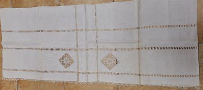 an image of a white table runner on a tiled floor