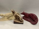 deux figurines représentant un chien et un chat posées sur une surface blanche