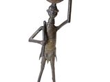 bronze statue of a woman holding a basket on her head