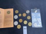 some coins are sitting on a table next to a pamphlet