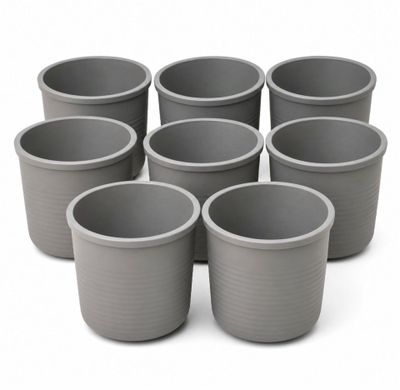 six gray plastic cups are arranged in a circle on a white surface