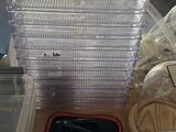 a stack of plastic containers sitting on a table next to a window