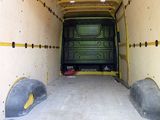 a green van that is parked in the back of a truck