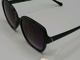 the sunglasses are black and have a tag attached to them