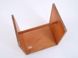 a small wooden box that is open on a white surface