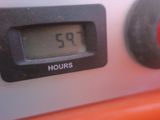 a close up of a digital clock on a gas stove