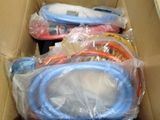a cardboard box filled with different colored hoses
