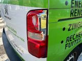 a green and white van parked on the side of the road