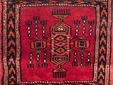 a close up of a red rug with a pattern on it