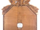 a wooden clock that is hanging on the wall