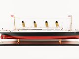 a model of a ship on a stand on a white surface