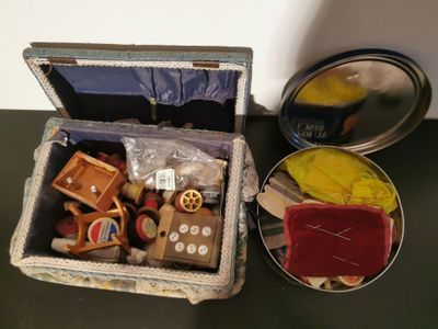 a small open suitcase sitting on a table next to a tin of tins