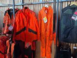 many jackets and jackets hanging on a rack in a store