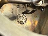 a close up of a metal object with a coin on it
