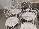 four chairs and a table in a room with a table and chairs