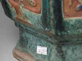 a large green vase with a design on it
