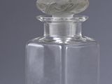 a small glass bottle with a lid on a table