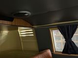 a couch in the back of a bus with a window