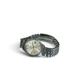 a watch that is sitting on a bracelet on a white surface