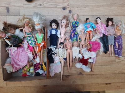 a lot of dolls sitting in a box on a table