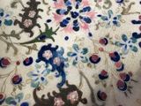 an image of a close up of a table cloth with a floral design on it