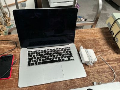 a laptop computer sitting on top of a wooden desk