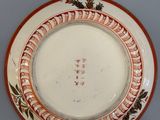 a white plate with a red border on it