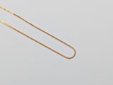 a gold necklace with a chain that is attached to it