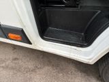 an image of a white golf cart with the door open