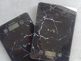 two electronic scales sitting on the floor next to each other
