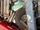 a red box filled with assorted tools on top of a table