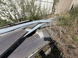 a pile of broken windows on the side of a building