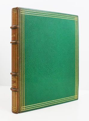 a green book sitting on top of a white table
