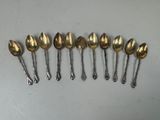 six spoons are lined up in a row on a table