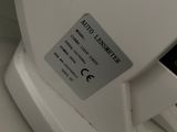 an image of a close up of a toilet seat with a button on it