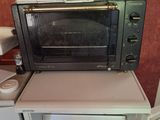 a toaster oven sitting on top of a small refrigerator