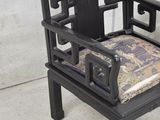 a black chair with a cushion on top of it