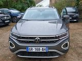 the front view of a grey volkswagen suv parked in a parking lot