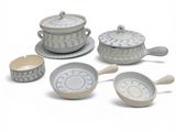 a group of dishes and spoons sitting on a white surface